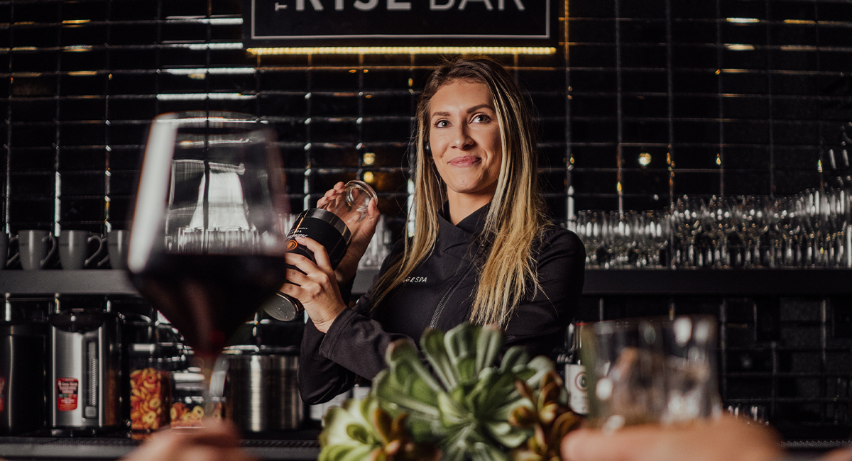 Woman bartending at The Rise Bar at The Refuge Spa
