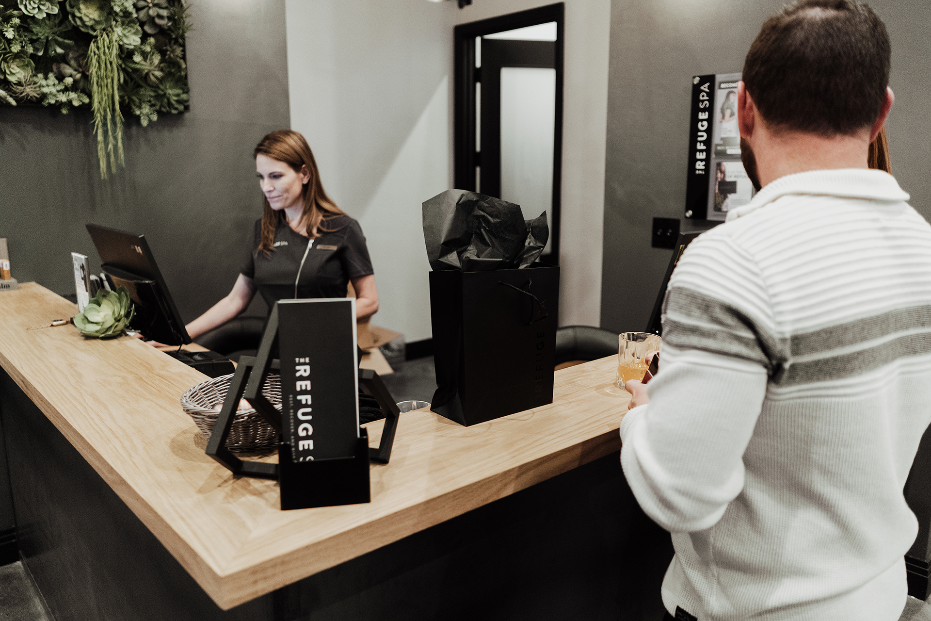 Refuge Spa assisting clients.